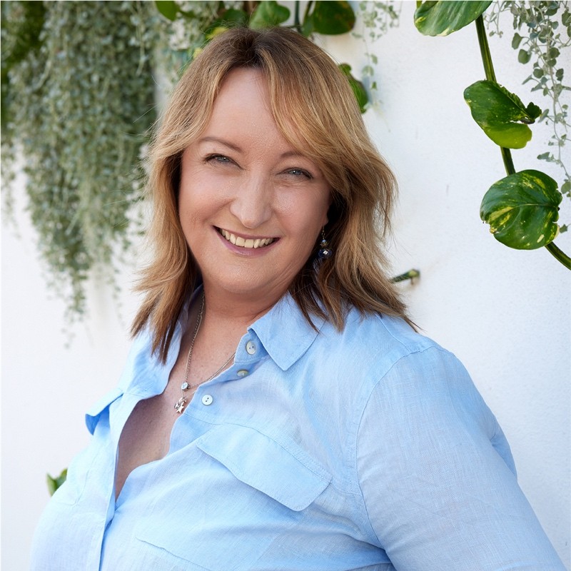 A woman smiles towards a camera featured image